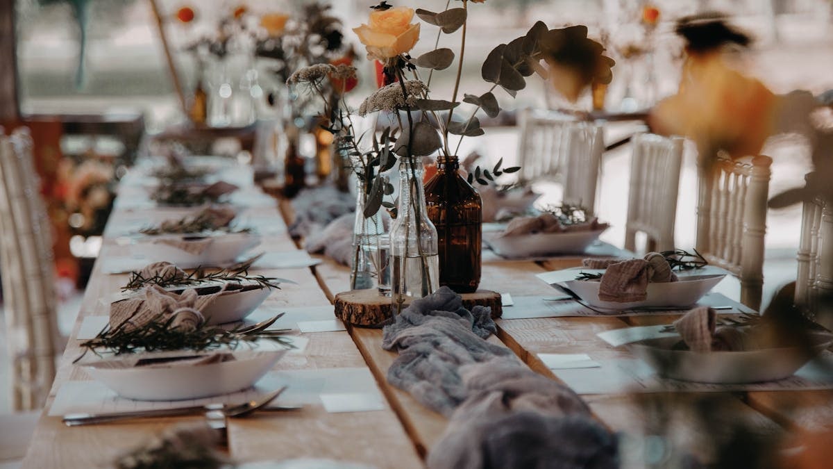 Beautifully arranged dining table with florals, ready for a special outdoor gathering.
